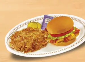 Crispy and flavorful Chicken Bacon Sandwich deluxe with hashbrowns Waffle house